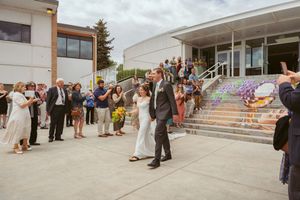 Guests gather on the white steps of a modern building during a summer event.