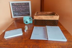 Multiple spiral notebooks and study materials laid out on a wooden desk surface for academic work.