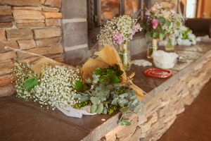 Rustic wooden decor elements paired with fresh flowers create an elegant display.