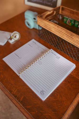 Empty lined notebook page on a brown leather surface ready for writing.