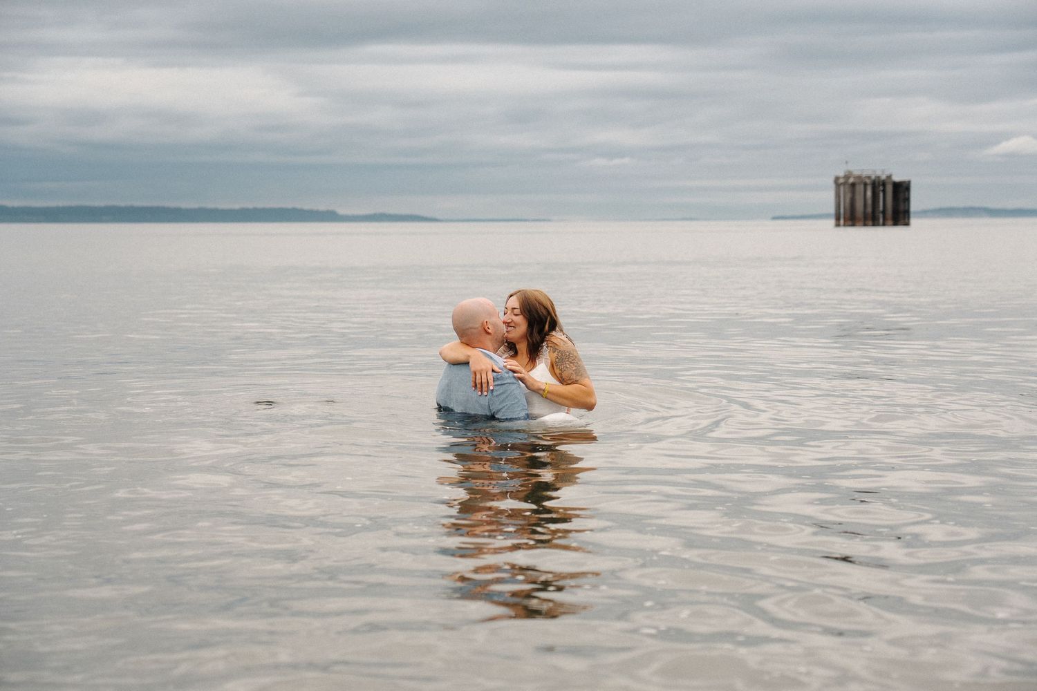 Person floats peacefully in calm salt water at the Bonneville Salt Flats during overcast conditions.