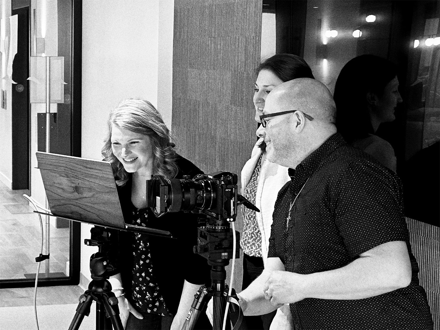 John Magnoski and his clients work together behind a camera setup during an architectural photography production shoot in Minneapolis, MN.