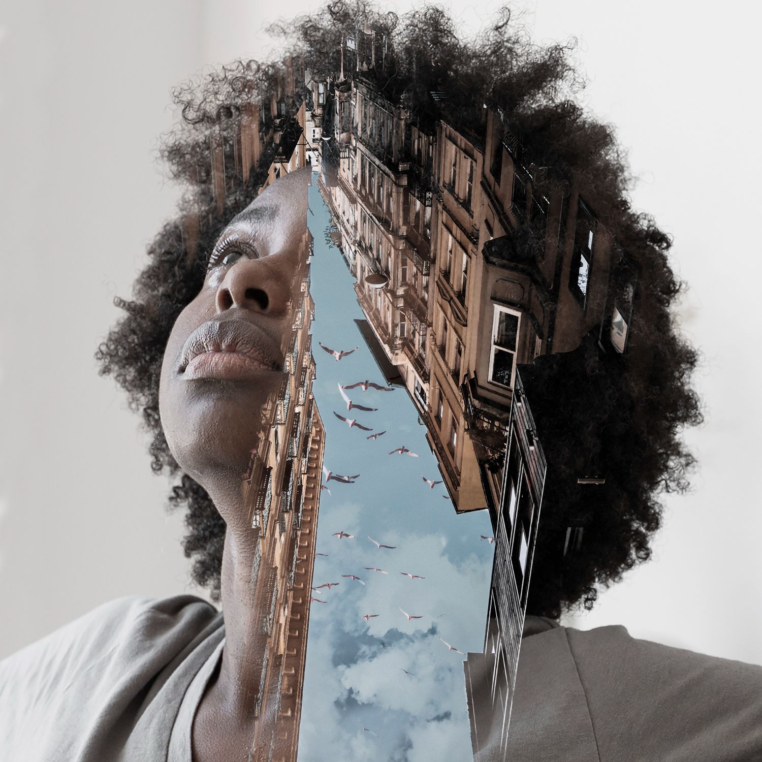 Creative double exposure portrait merging urban architecture and sky with birds in a circular frame composition.