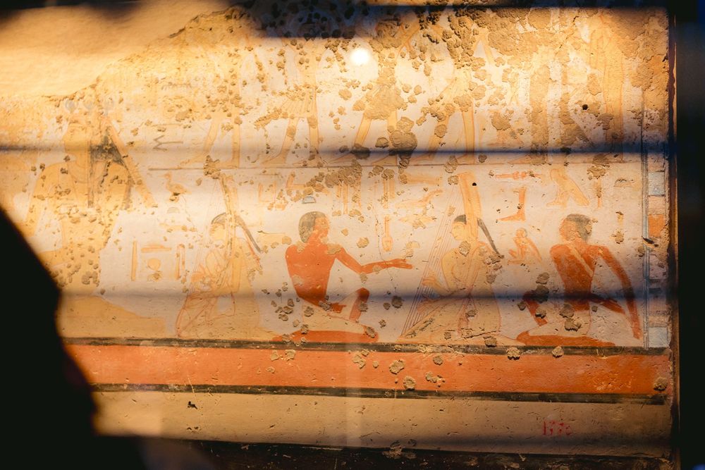 Vintage sepia photograph showing silhouettes on a textured, weathered surface.
