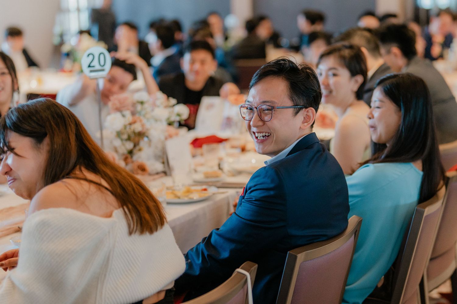 Guests enjoying a formal dining event in an elegant indoor venue with modern decor.