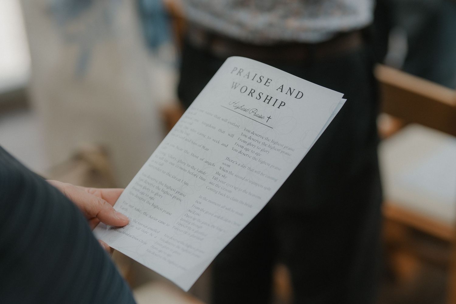Close-up of wedding ceremony programs being held during the service.