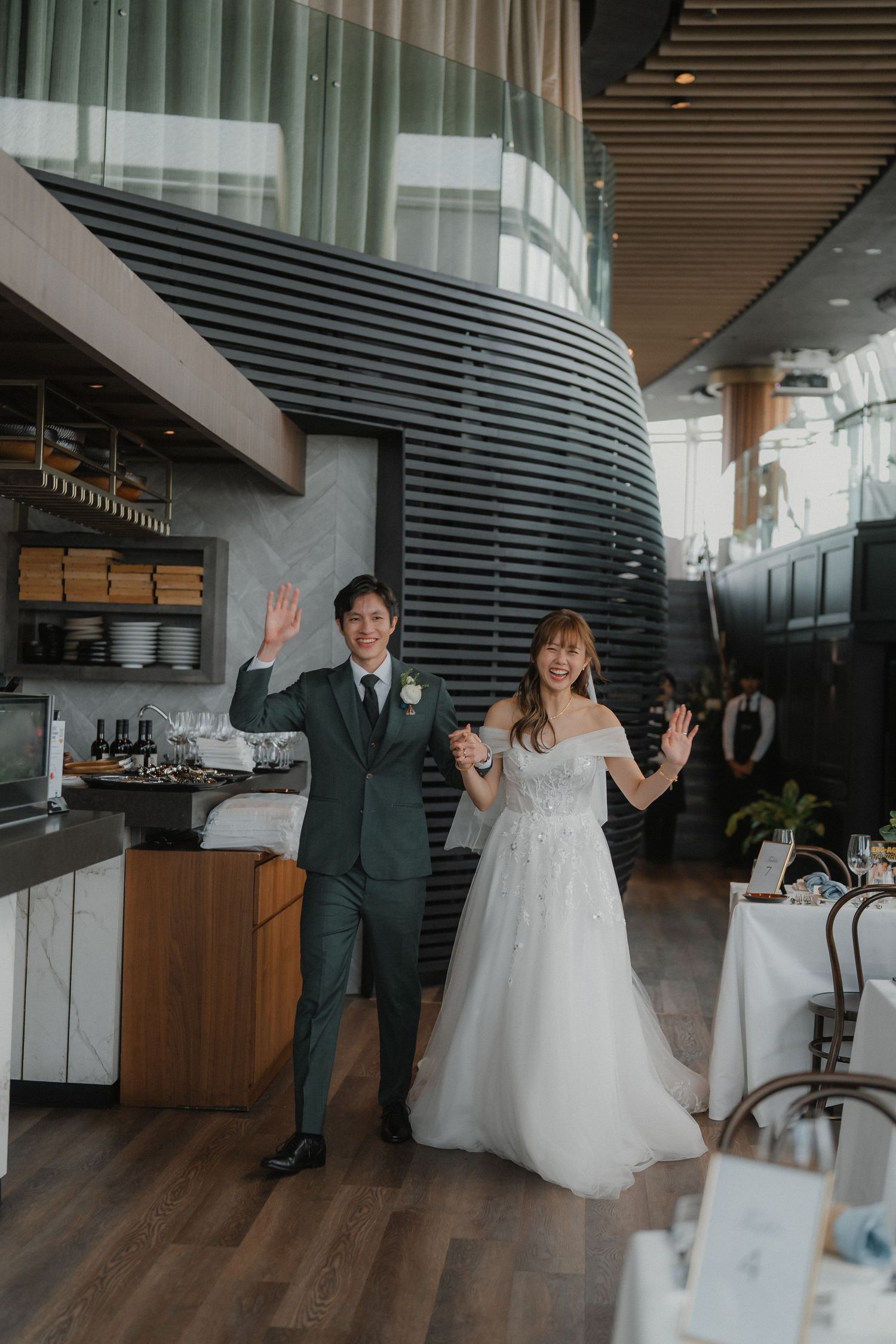 Modern restaurant interior with curved architectural details, wooden floors and contemporary design elements.