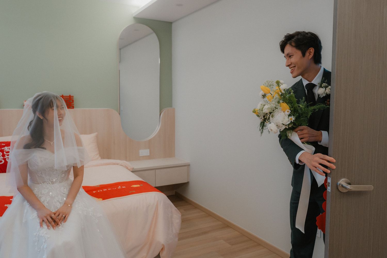 A romantic scene as yellow flowers are presented through a doorway during a wedding.