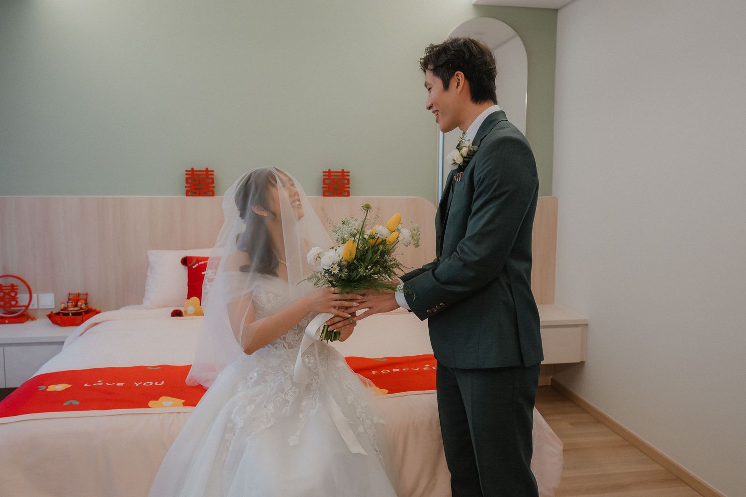 A special moment shared with yellow flowers in a minimalist room with red accents.