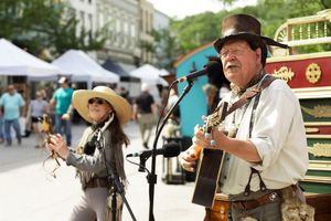 Event photo of a man and woman playing music at the Hannibal Twain on Main Festival in 2022
