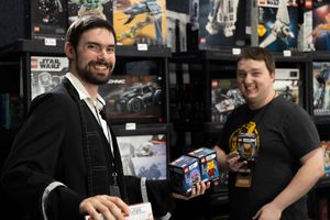 Event photo at Hannibal Big River Comic Convention of two men posing at their booth