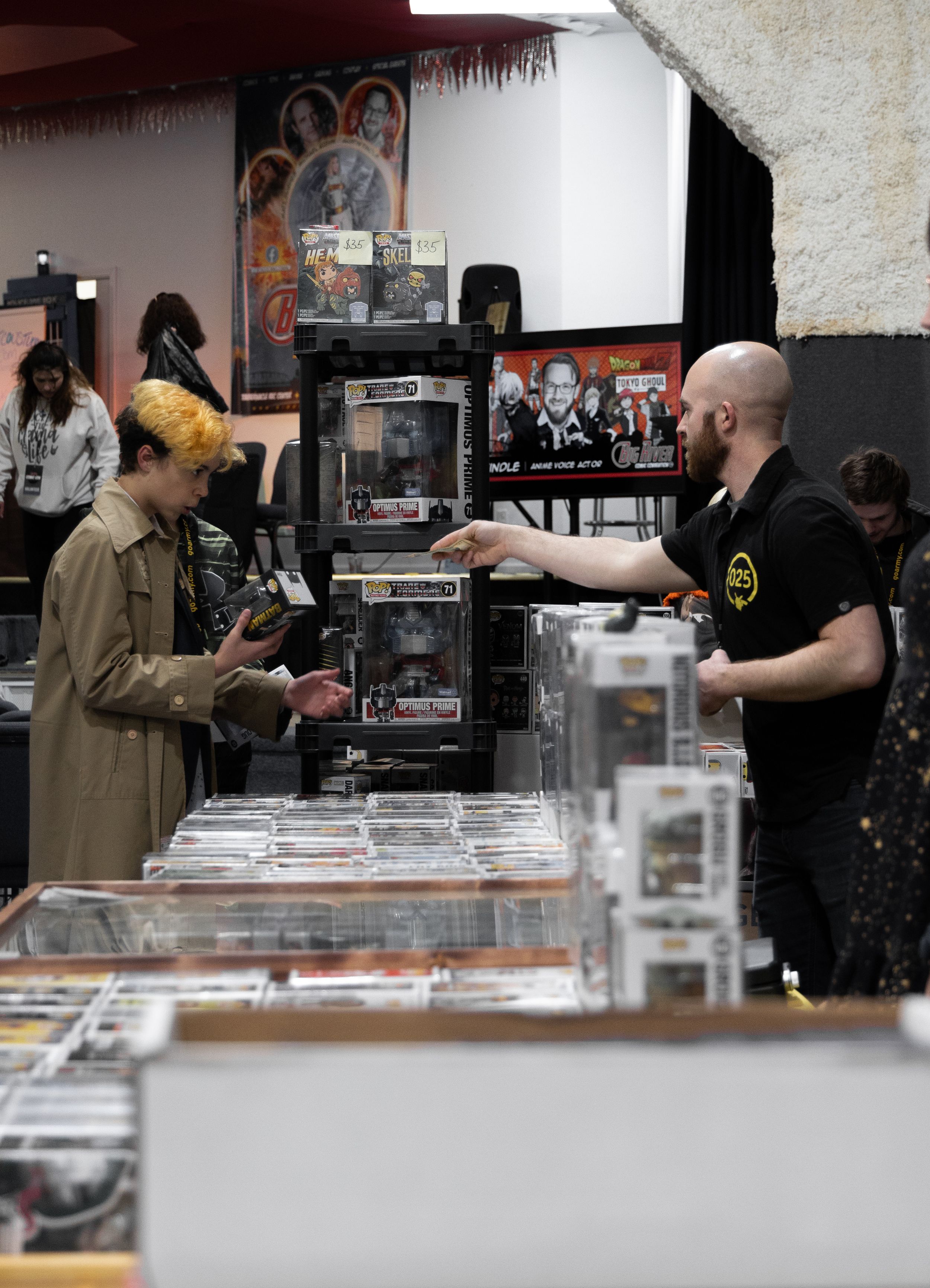 Event photo at Hannibal Big River Comic Convention of a man selling from his booth
