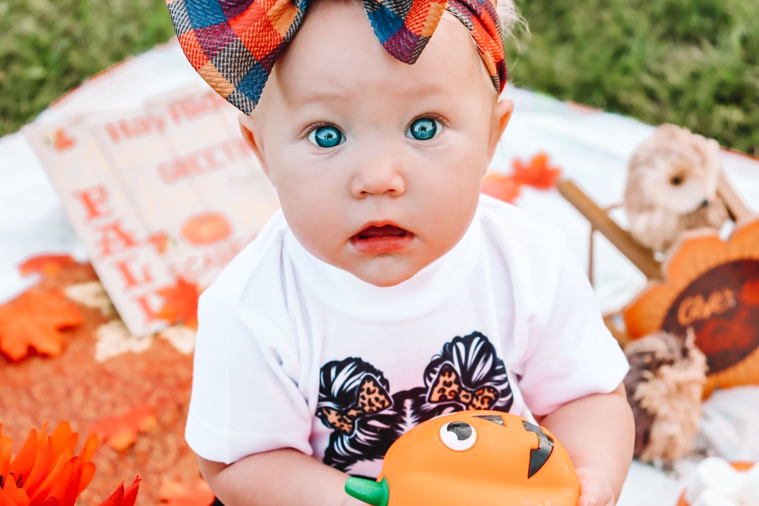 Close up photo series of a baby wearing an orange headband and white shirt.