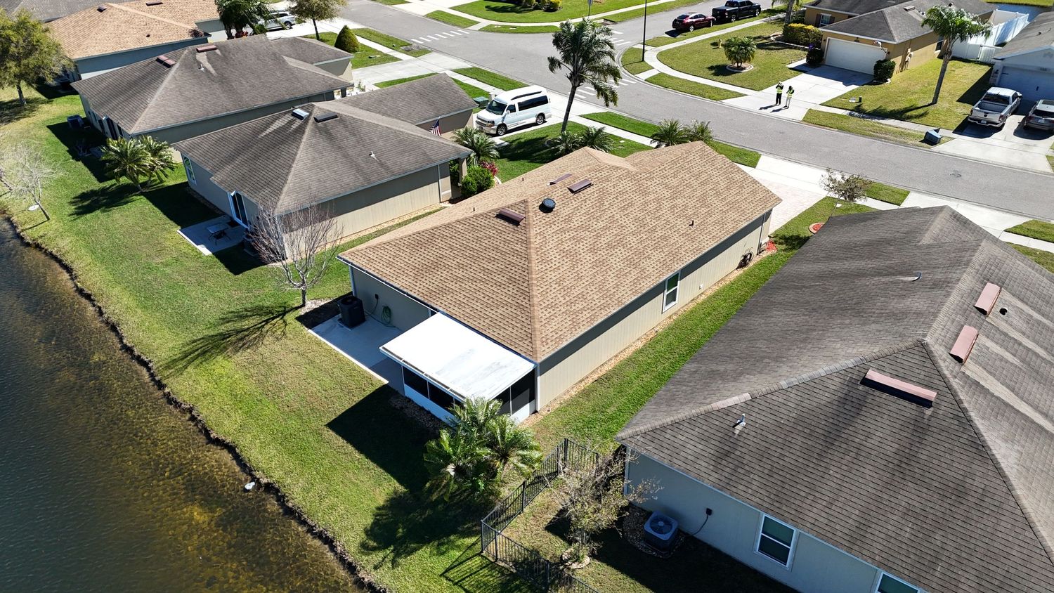 Aerial perspective of residential street with single-story homes and attached garages.