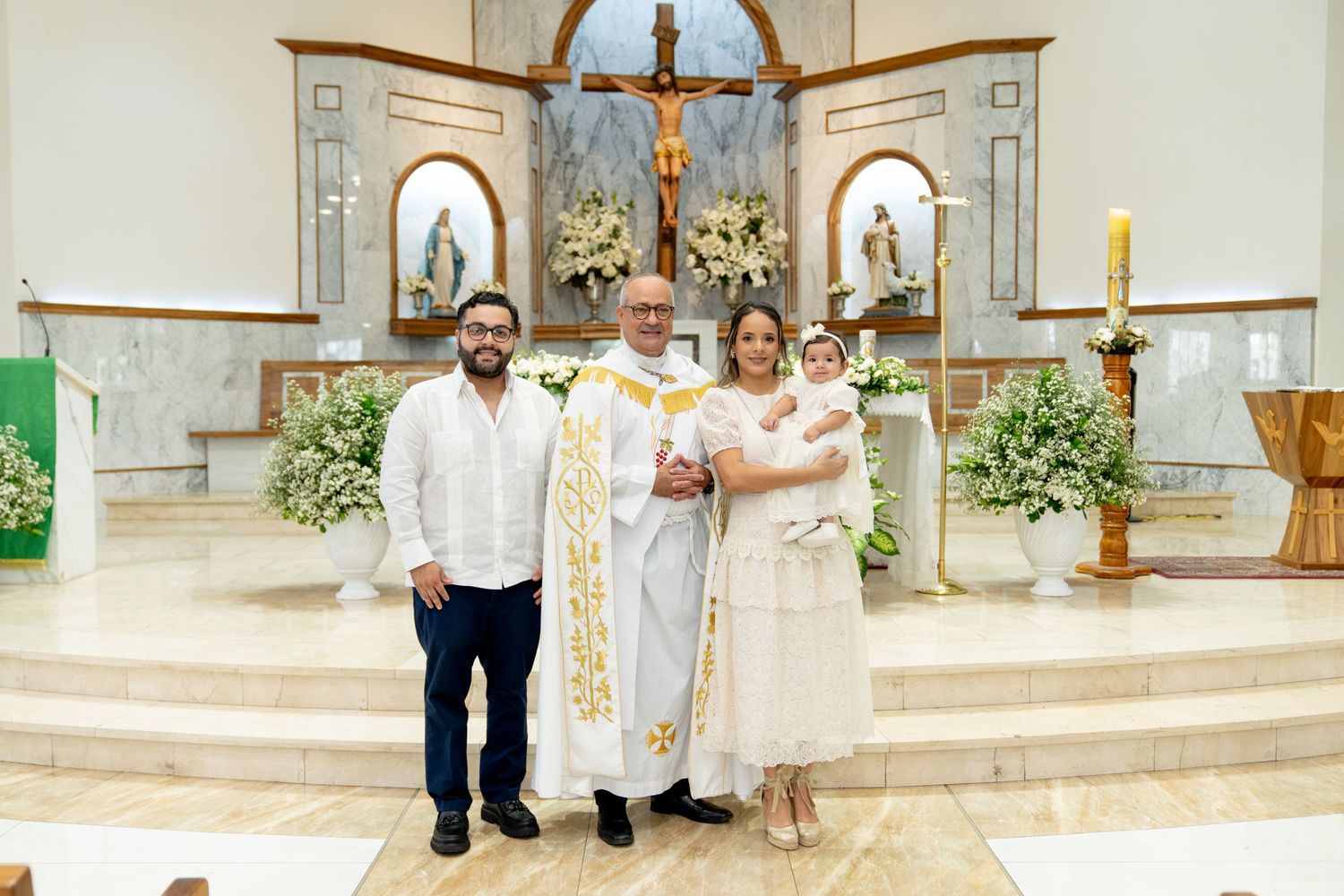 Religious ceremony taking place in a beautifully decorated church altar with floral arrangements.