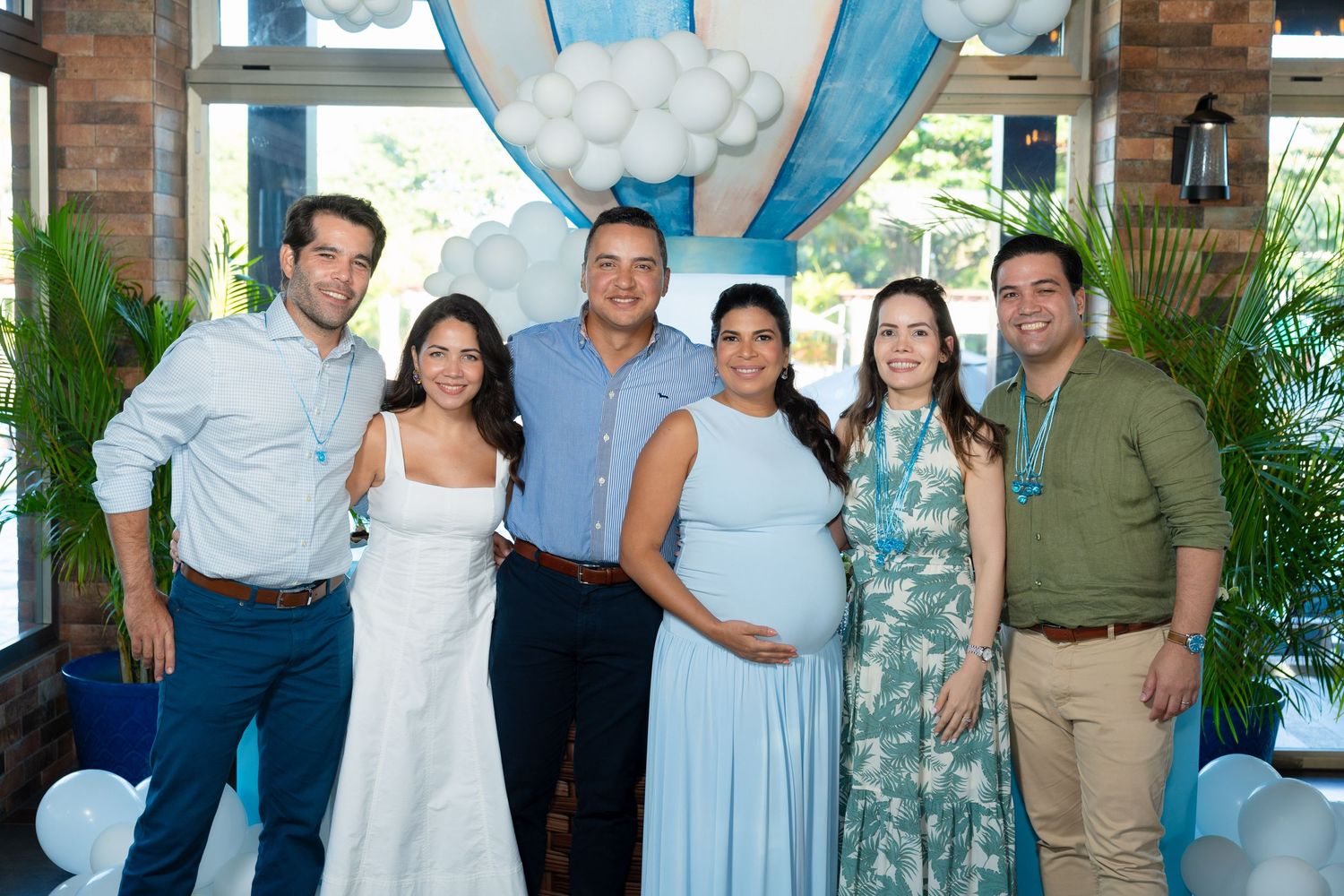 A series of casual group photos at a social gathering with people wearing light blue and white attire.