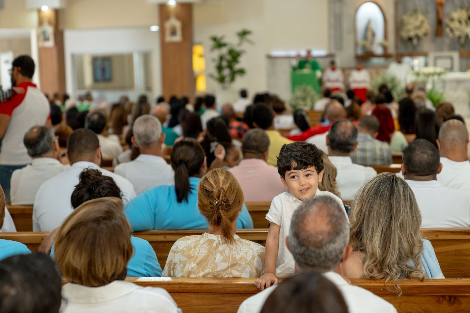 Large congregation gathered in a church sanctuary for a religious service.