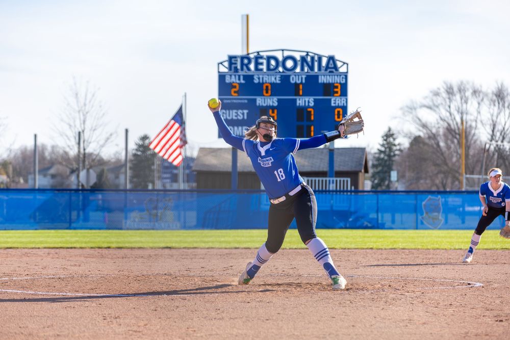 Softball players in blue uniforms compete during a game at Fredonia's baseball field.