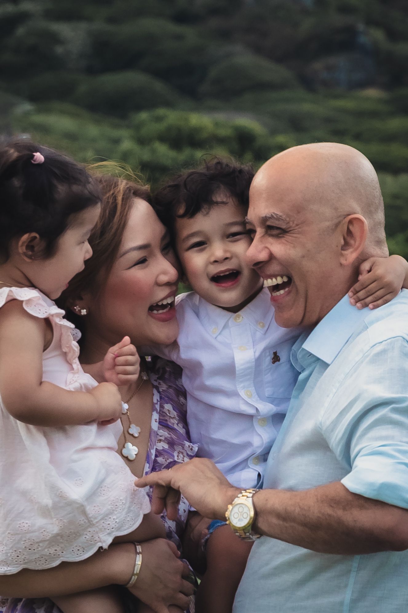 A joyful family moment shared between parents and children outdoors.