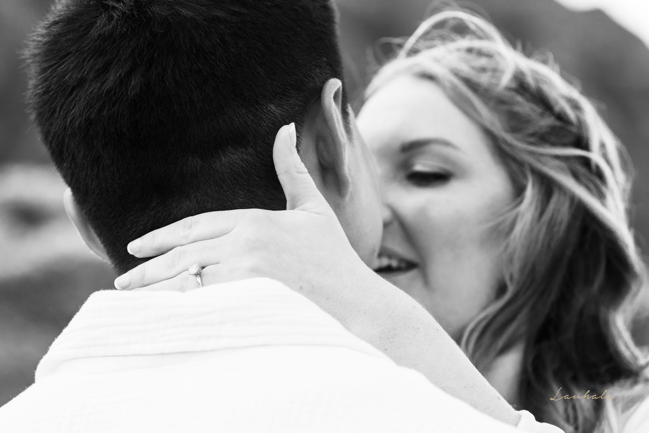 An intimate black and white portrait of a couple sharing a romantic moment.