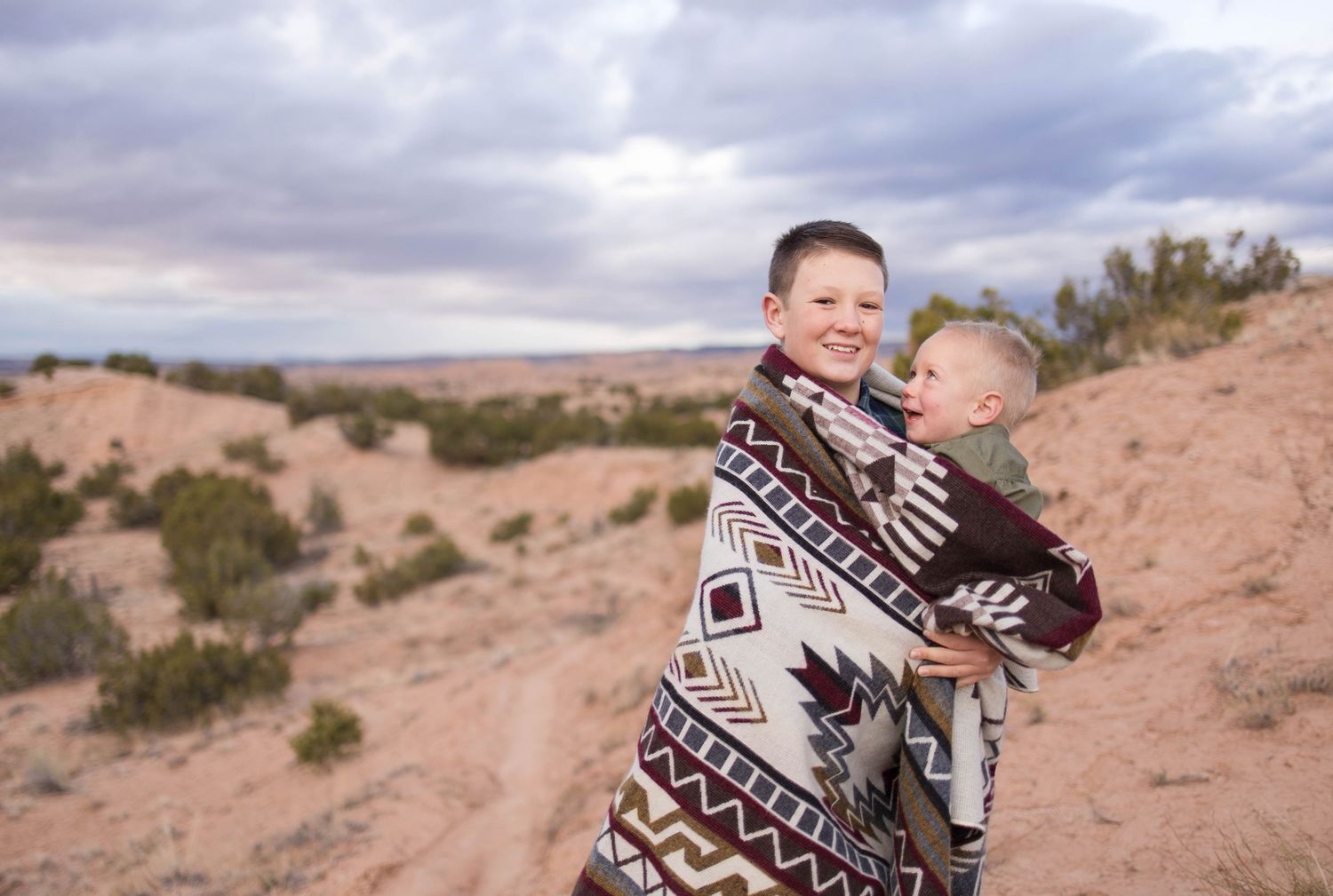 Big brother with baby brother in desert