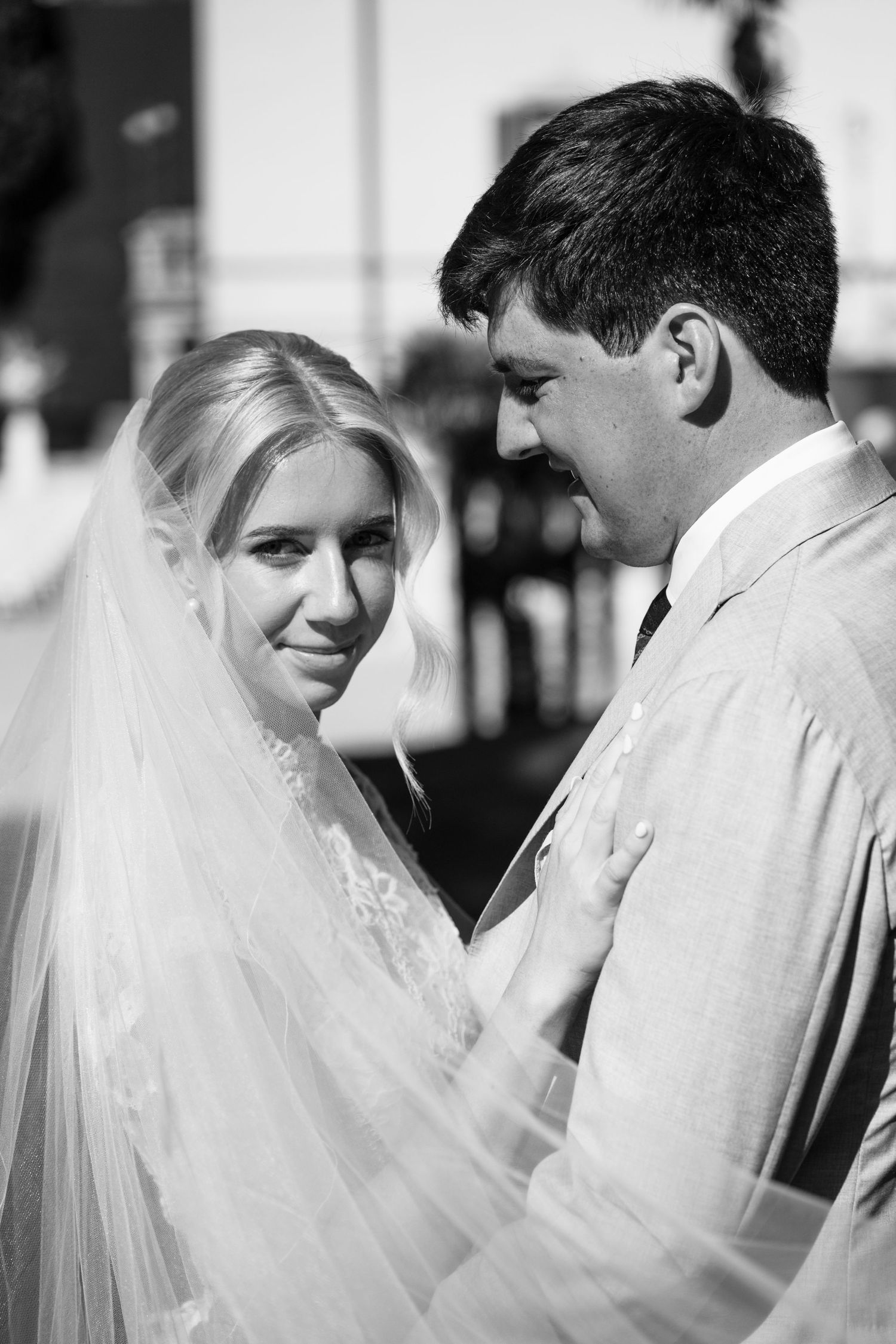 Black and white wedding photo sequence showing tender moments between a bride and groom in close-up shots.