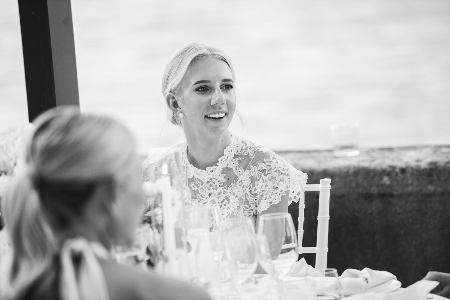 A black and white photo montage shows candid moments from a wedding celebration with guests at tables.