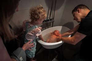 A series of photos showing hands carving and cleaning a pumpkin for Halloween decorating.