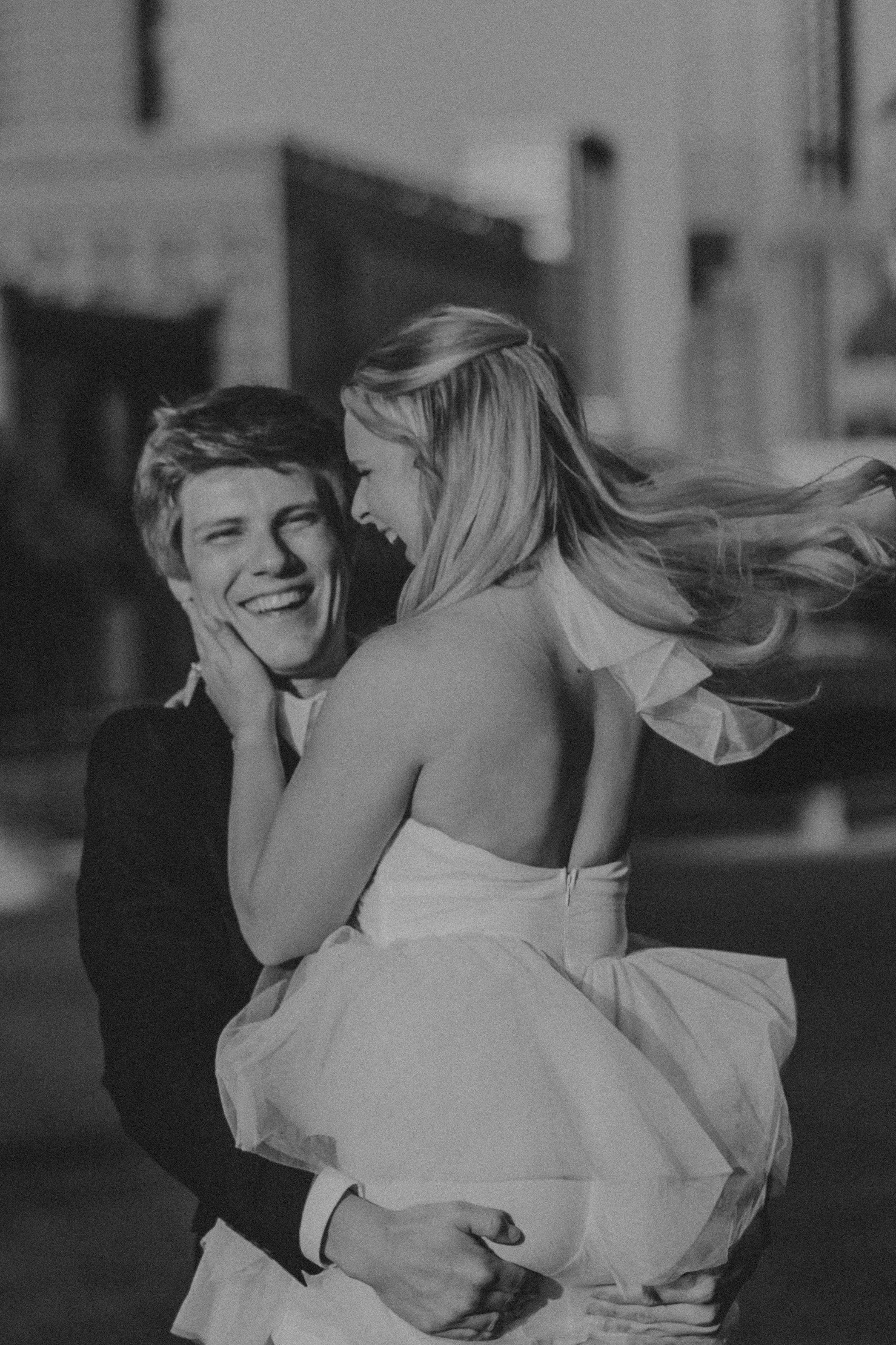 A romantic black and white photo sequence showing a couple embracing and spinning joyfully together outdoors.