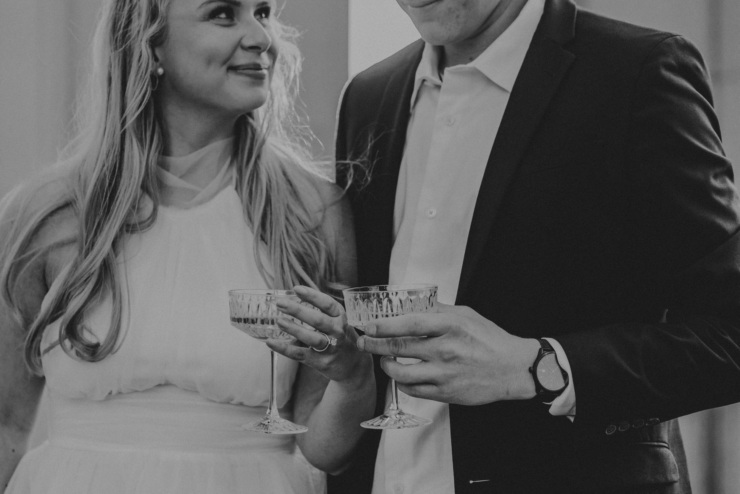 Black and white photo series showing couple sharing romantic moments and laughing together during engagement session.