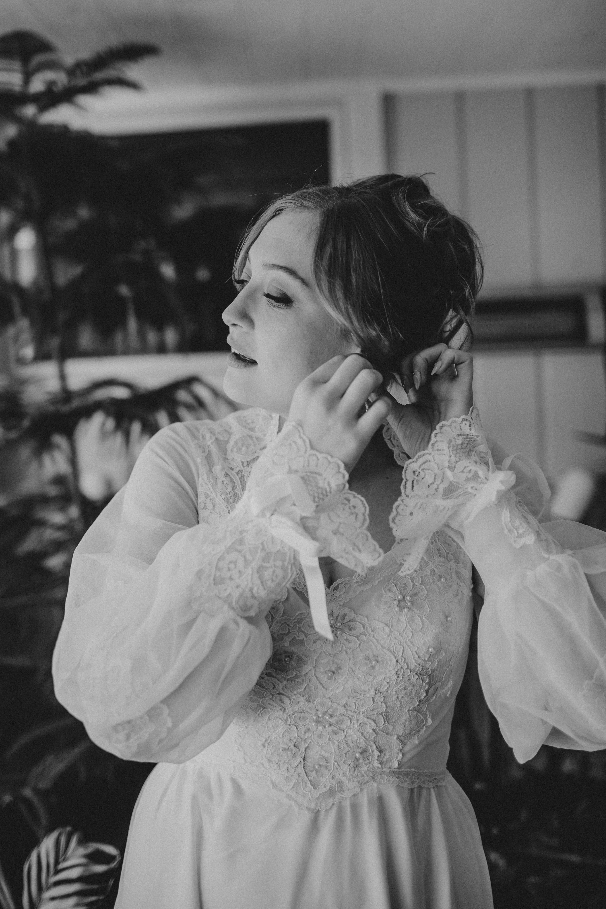 Close-up detail of intricate lace wedding dress bodice in black and white.
