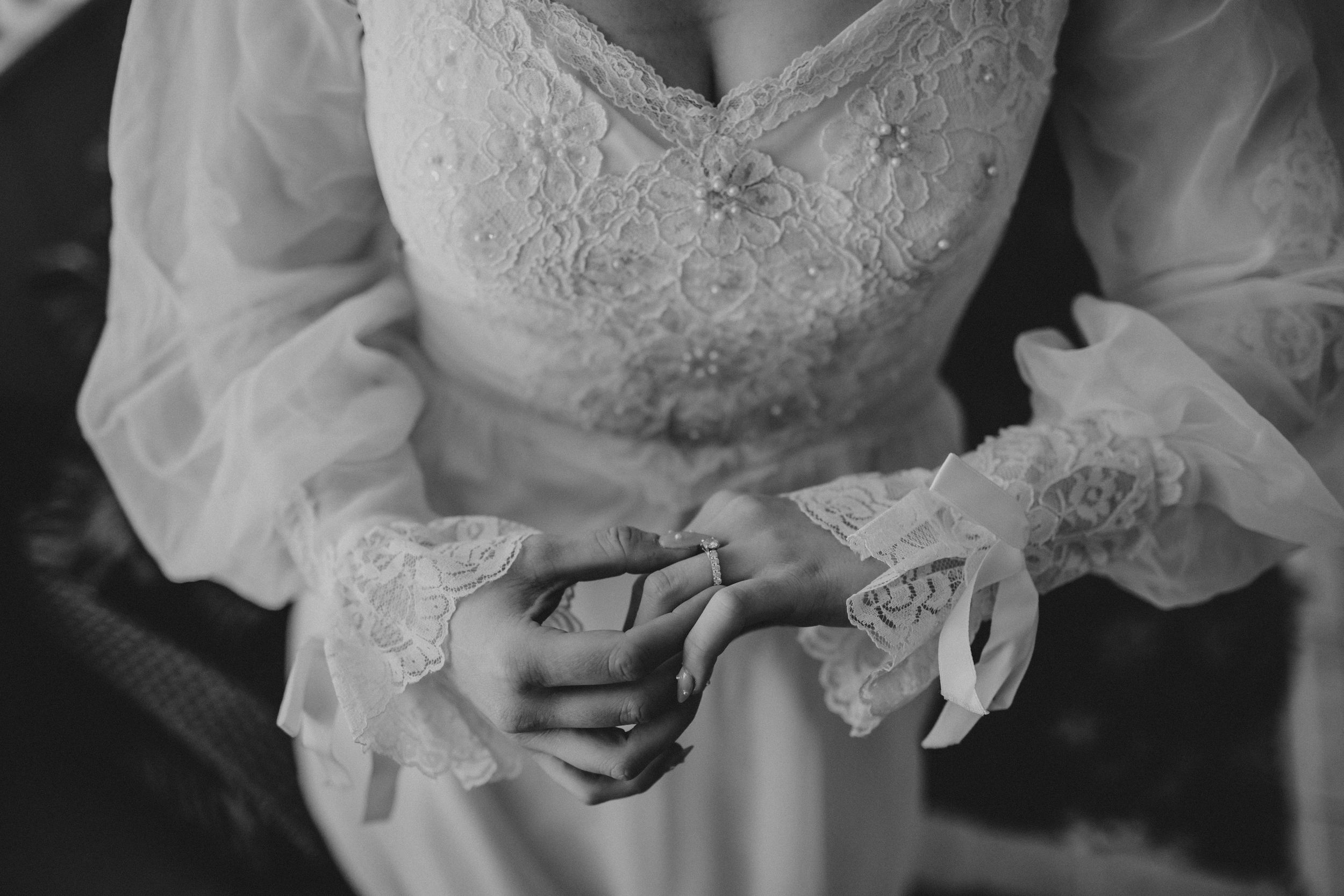 Detailed view of vintage-inspired wedding dress showing ornate lace patterns.