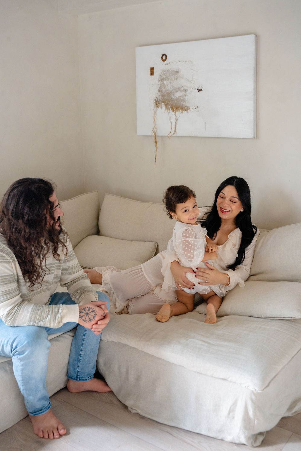 A series of playful moments captured on a white couch showing affectionate interaction in natural lighting.