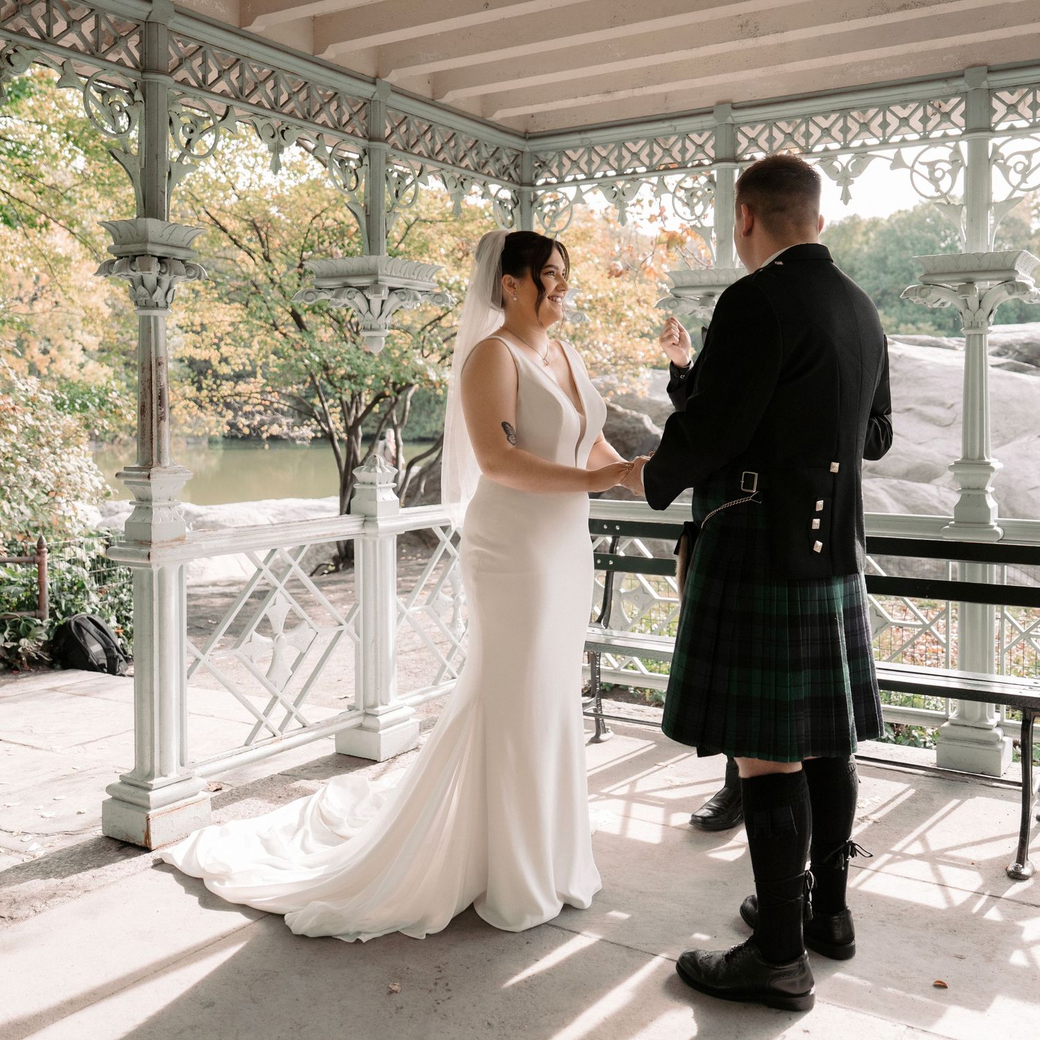 A wedding ceremony on a Victorian-style porch with the groom wearing a traditional Scottish kilt.