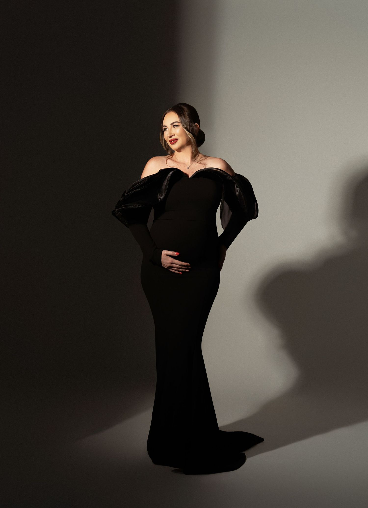 A flowing mauve tulle gown creates an ethereal effect in a series of artistic boudoir portraits against a dark background.