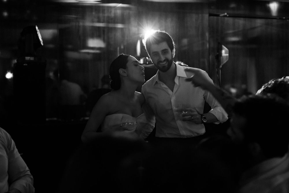 Black and white photos of people dancing in a dimly lit nightclub or bar setting.