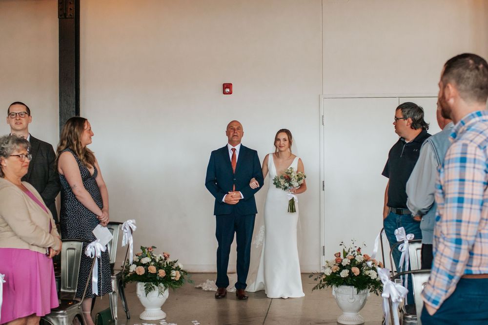 A sequence of wedding ceremony moments showing guests and the bridal party in a minimalist indoor venue.
