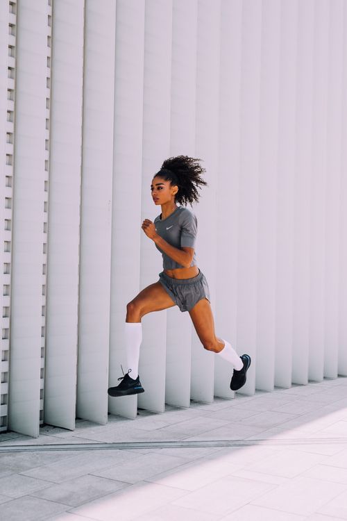 Artistic photo sequence showing a dancer leaping between white architectural columns in a minimalist space.