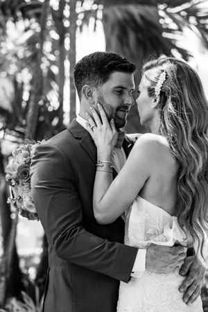 A series of romantic black and white wedding photos showing tender moments between newlyweds in an outdoor setting.