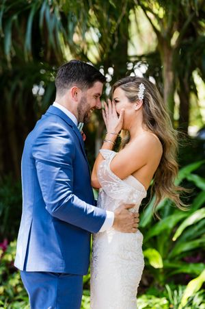 Romantic first look moment captured in a lush garden setting.
