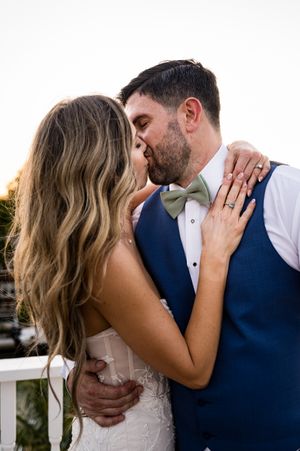 Tender wedding day kisses captured in a series of romantic outdoor portrait shots.