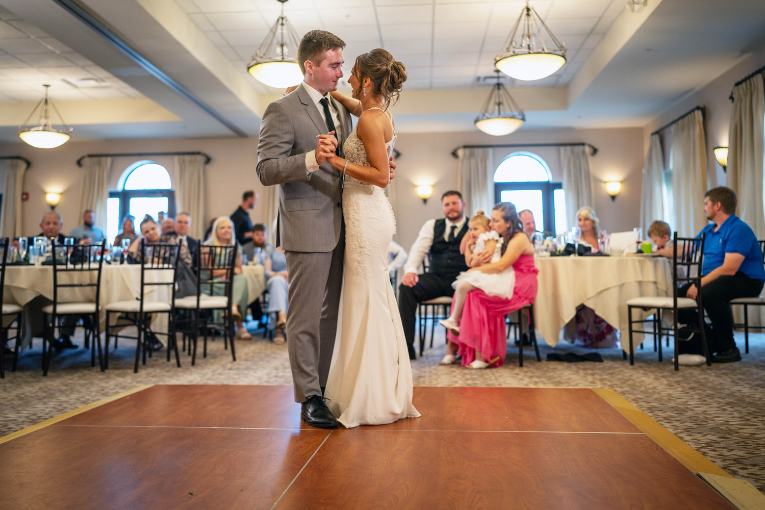 A couple shares their first dance in an elegant ballroom reception venue the club at corazon