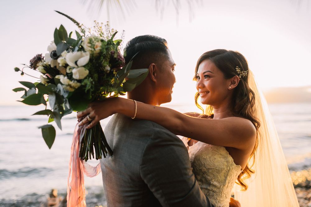 Golden hour wedding portraits with ocean waves in background.