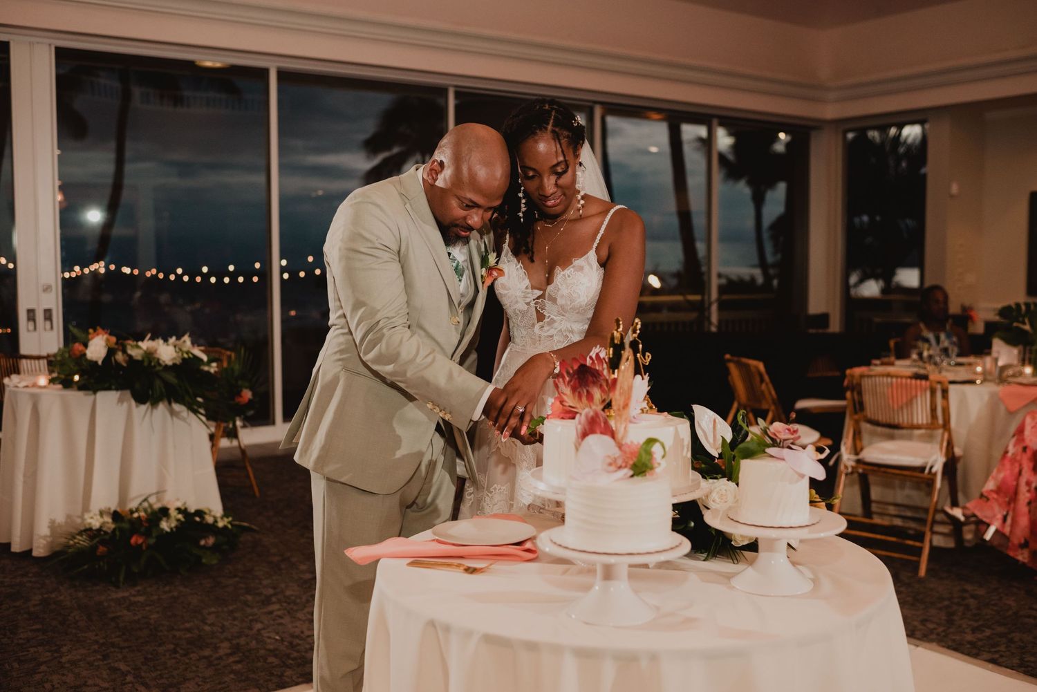 Wedding reception celebration with elegant table settings and ambient lighting.