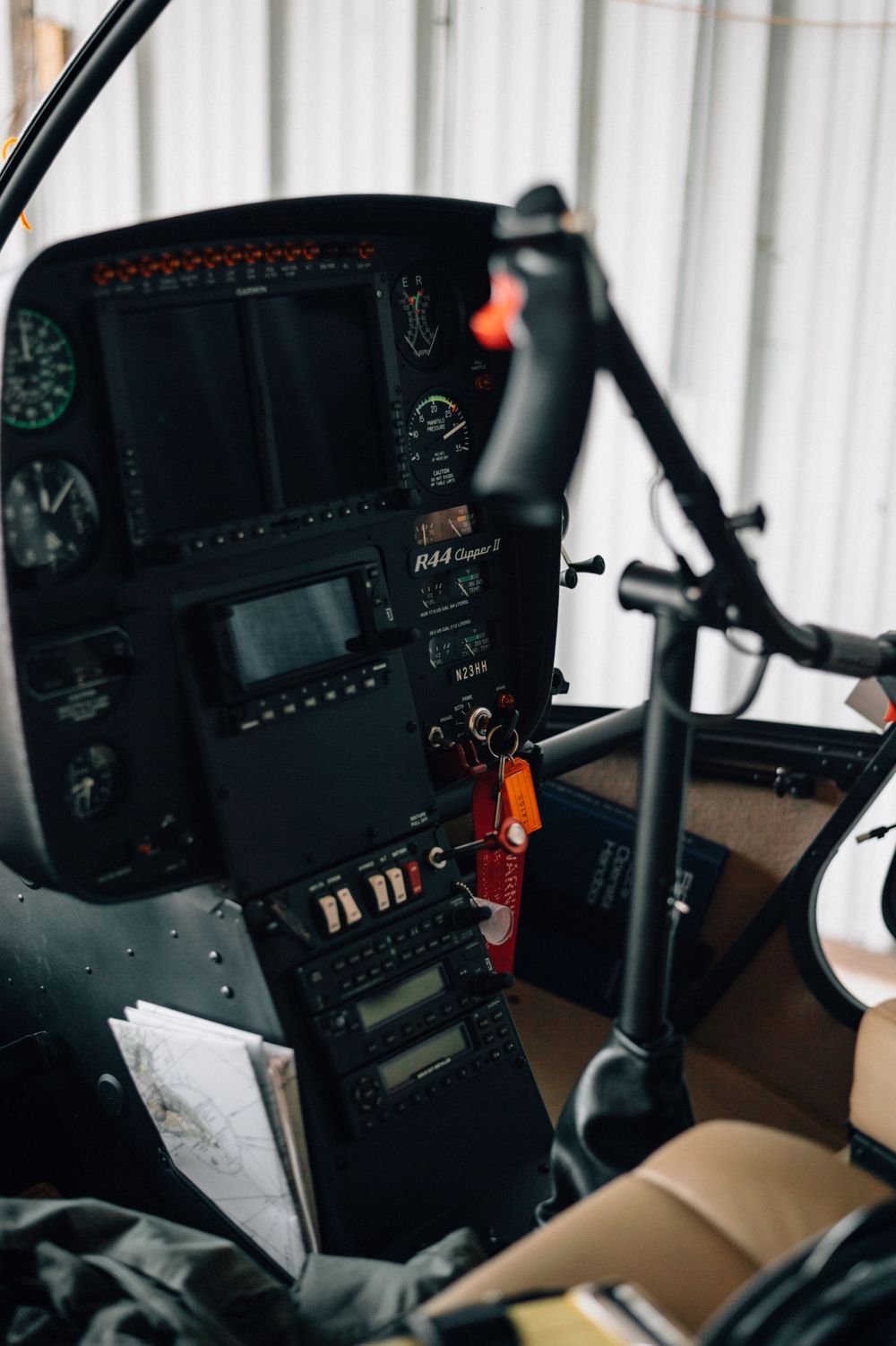 Modern aircraft instrument panel with digital displays and controls in dark lighting.