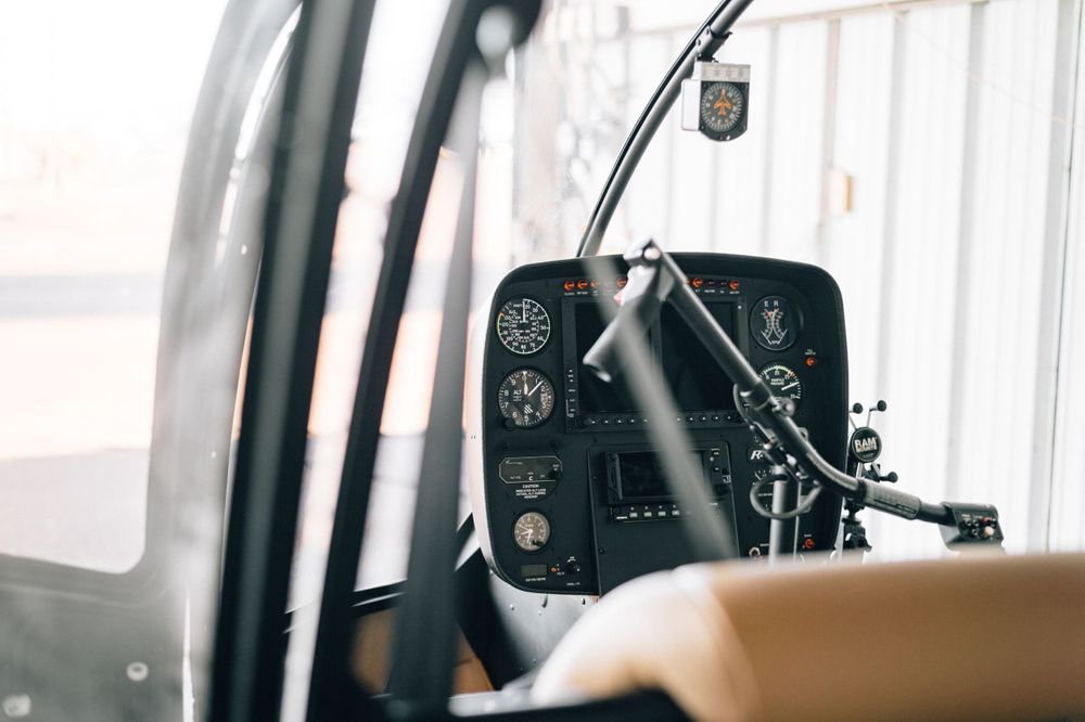 Interior view of helicopter cockpit instruments and controls.