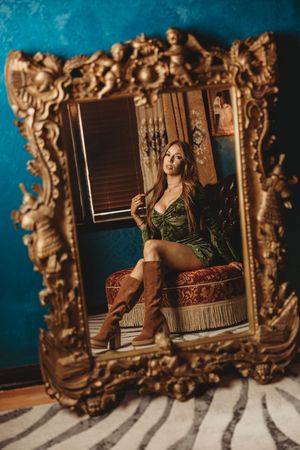 Elegant vintage scene with decorative gold mirrors and warm lighting creating moody ambiance.