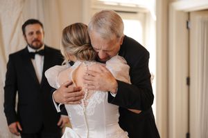 Black and white wedding photo series showing tender moments between couples dancing and embracing at a reception.