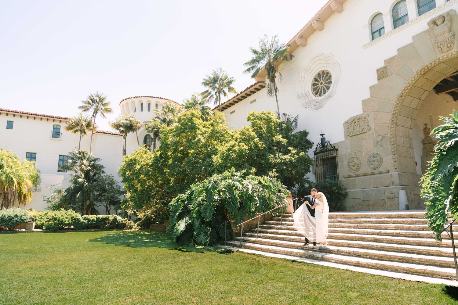 A series of connected Mediterranean-style architecture photos showing stone buildings with palm trees and curved staircases.