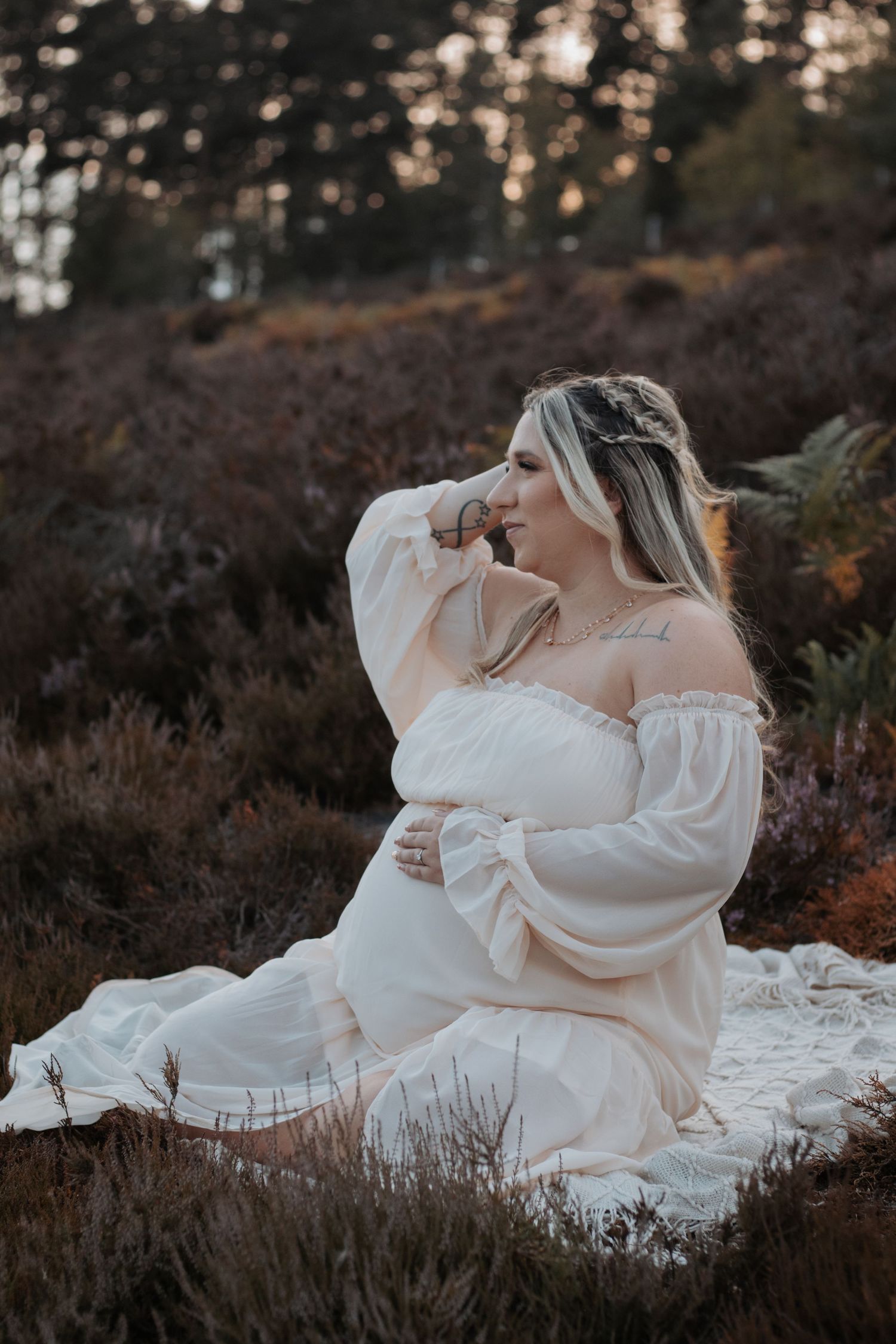 Artistic maternity photos showing a pregnant belly with a white button-down shirt.